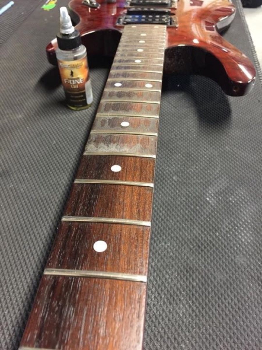 Cleaning guitar fretboard with Lemon Oil Compound. 